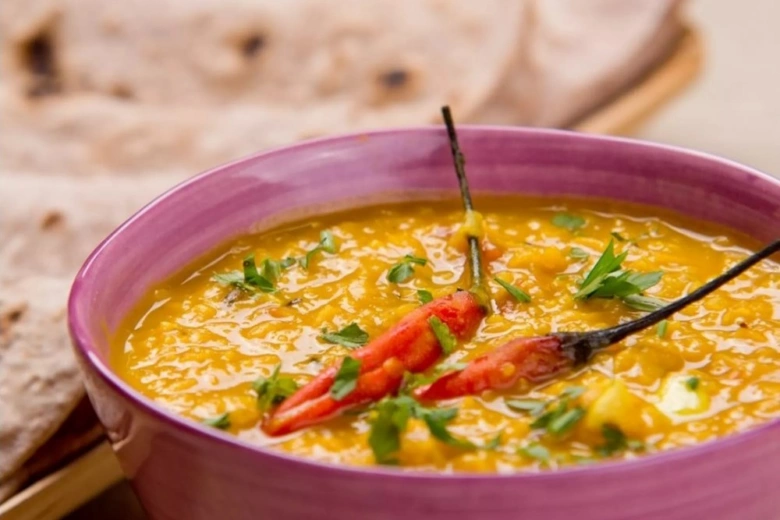 Indická polévka z čočky s chilli papričkami a plackou.