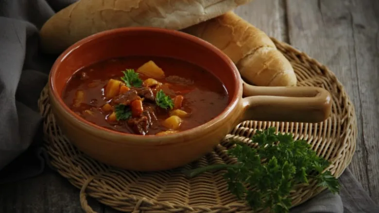 Hot Czech Frankfurt soup with vegetables and sausage pieces.