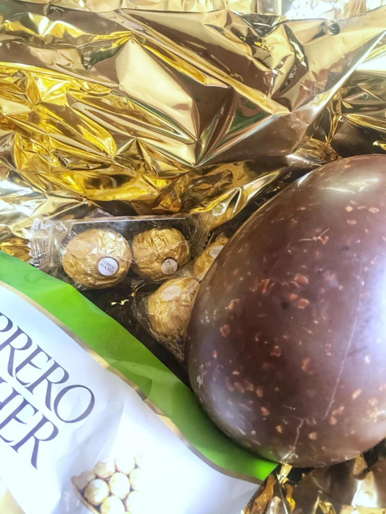 Zlaté čokoládové koule Ferrera Rocher v zlatém obalu.