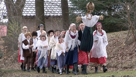 People in traditional costumes with effigy