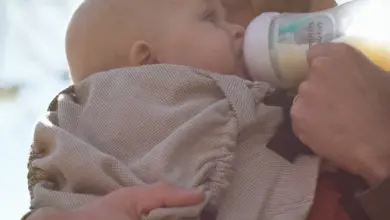 Father feeding baby outdoors